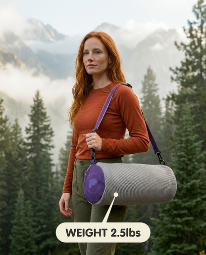 Woman holding a cylindrical gray and purple chair bag with a mountainous background